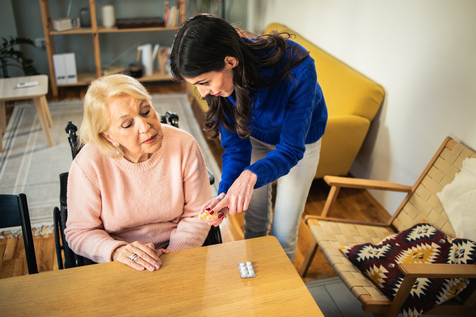 Volunteer helps an elderly person with daily activities