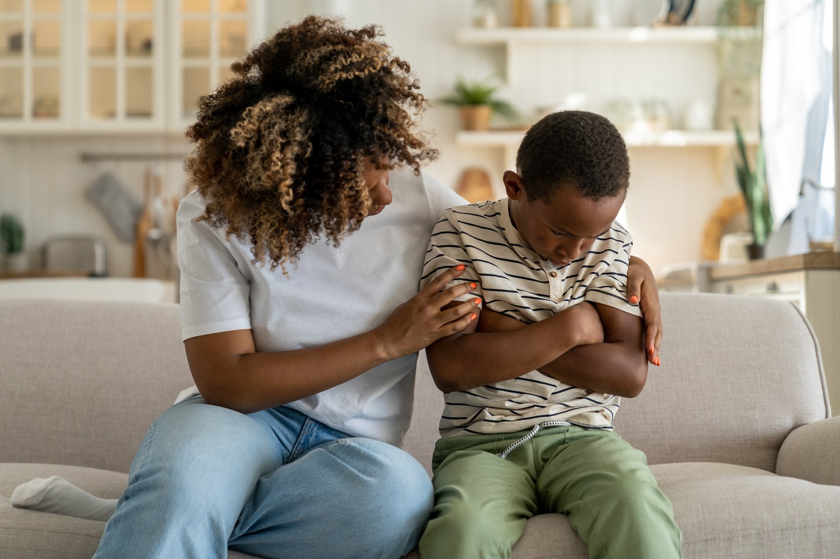 Loving African American Mother Embracing Sad Offended Little Son, Giving Support to Child